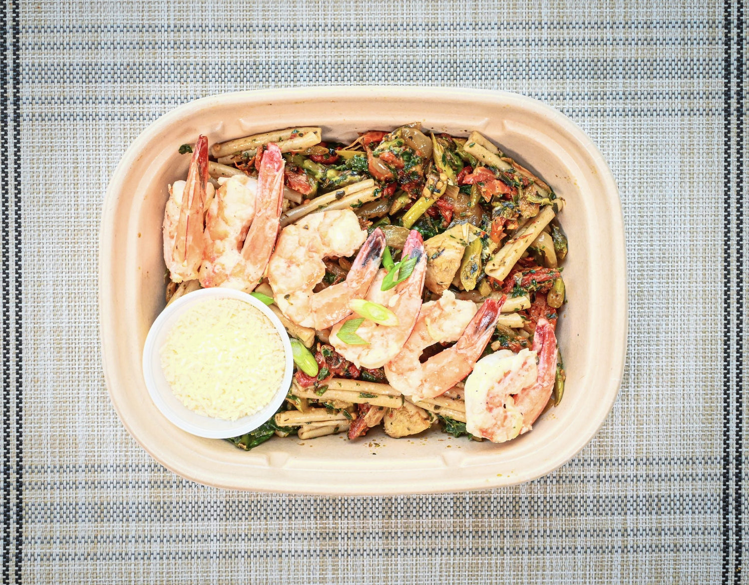 Nourishing and delicious, fresh meal. Shrimply Irresistible - wild caught Mexican brown shrimp with brown rice pasta and spinach, artichoke, sundried tomato pesto with pecorino romano cheese